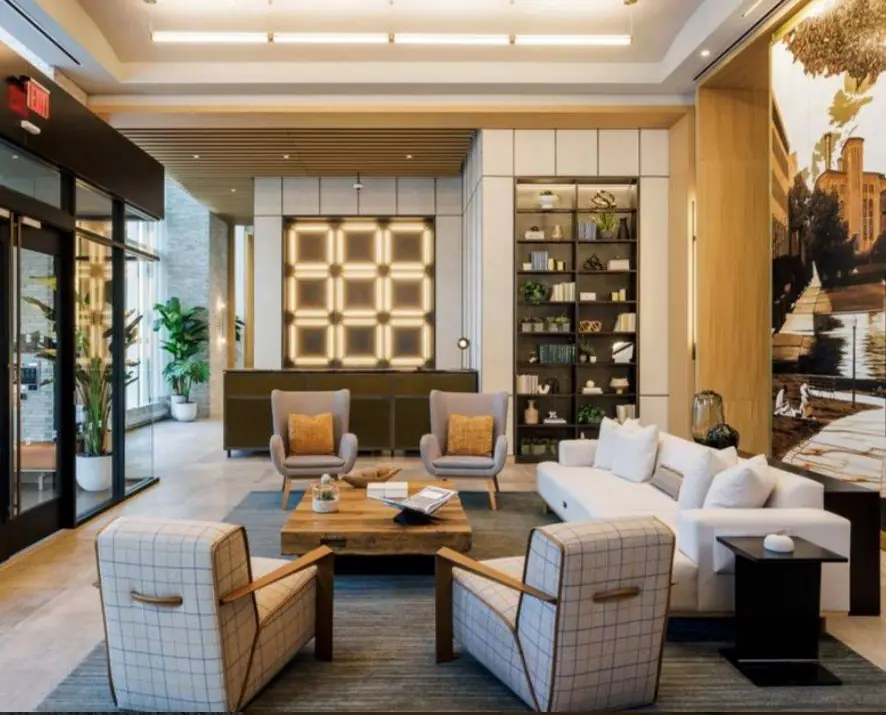Plaid lounge chairs and a white sofa in the amenity lounge at Haus 25, New Jersey