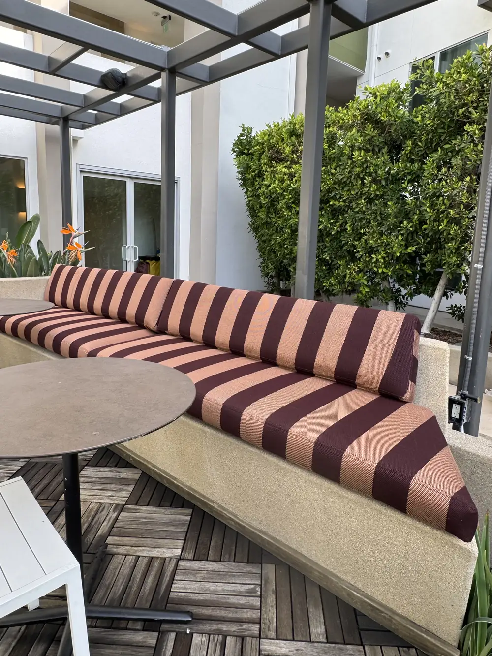 Striped seat and back cushions on a built-in corner bench at The Brio, Glendale